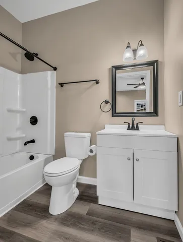 a bathroom with a sink toilet a mirror and shower