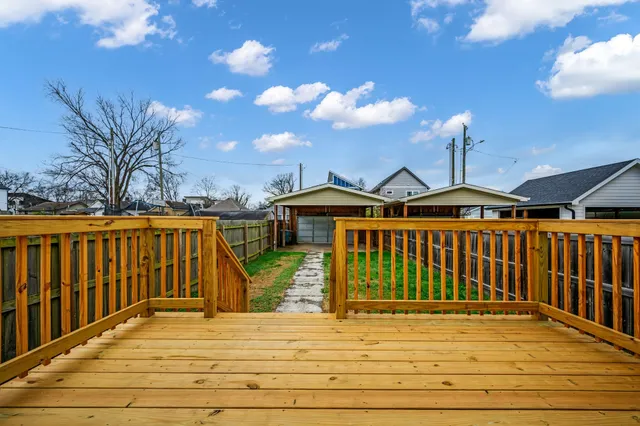 a view of a brick house with wooden fence
