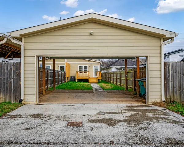 a front view of a house with a garden and plants