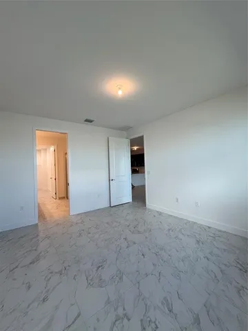 a white toilet sitting next to a white cabinet