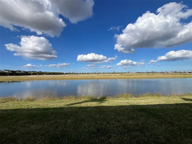 a view of a lake with houses in the back