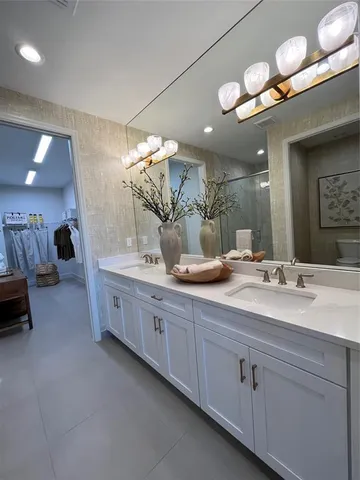 a bedroom with a bed and a mirror on the dresser