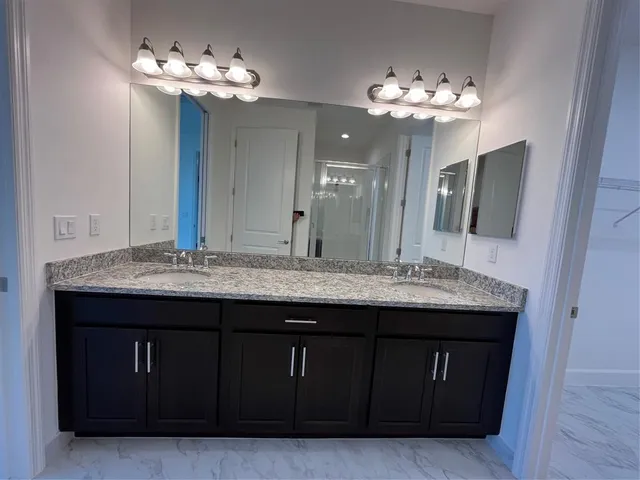 a view of an empty room with wooden floor and windows