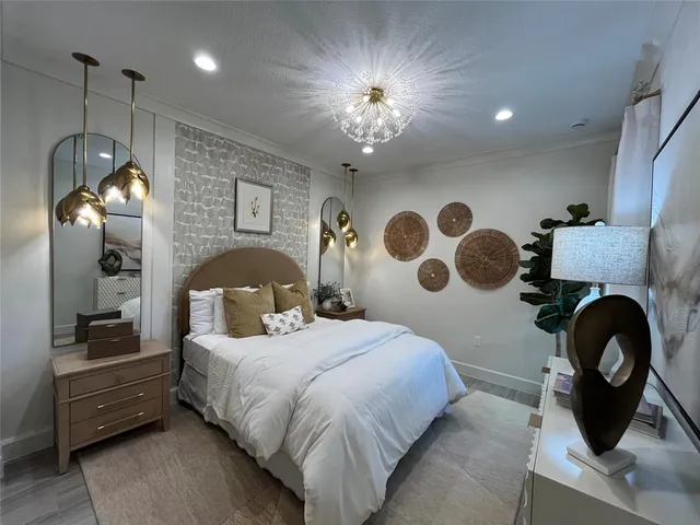 a living room with furniture a window and a potted plant