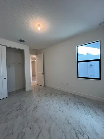 a view of a room with a ceiling fan