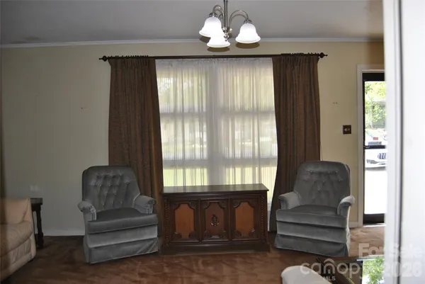 a view of entryway with wooden floor and a chandelier