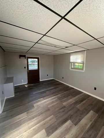 a view of a livingroom with wooden floor and window