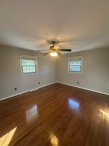 a view of a livingroom with wooden floor and window