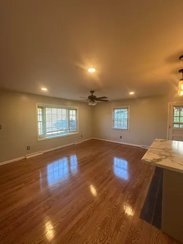 a view of a room with wooden floor and window
