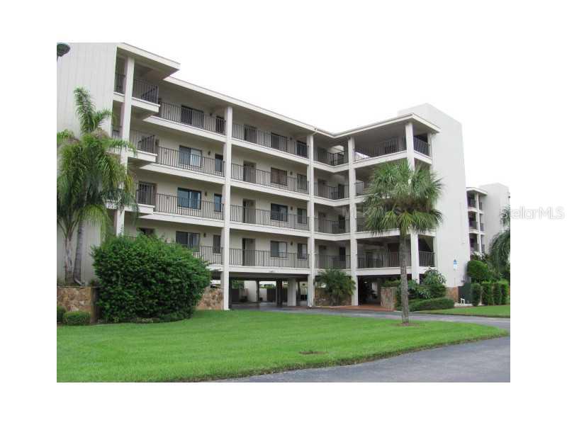 8251 Brent Street, Unit 912 Port Richey, FL 34668 - Photo 1 of 1 a front view of a building with a garden
