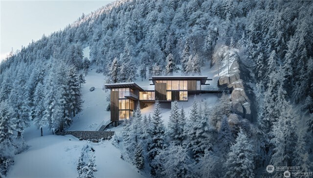 a backyard of a house with large trees and covered with wooden fence
