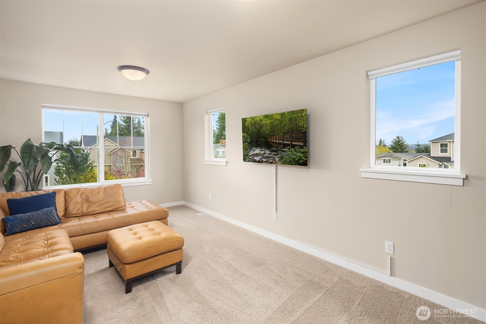 1435 242nd Place Southeast Bothell, WA 98021 - Photo 35 of 40 a living room with furniture and a flat screen tv