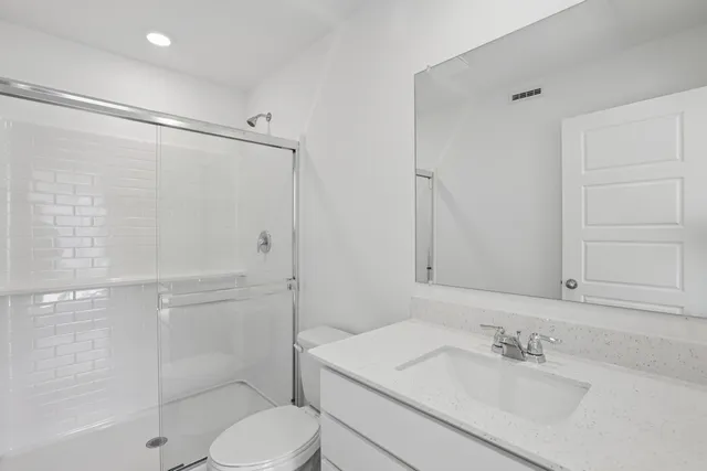 a bathroom with a sink toilet and shower