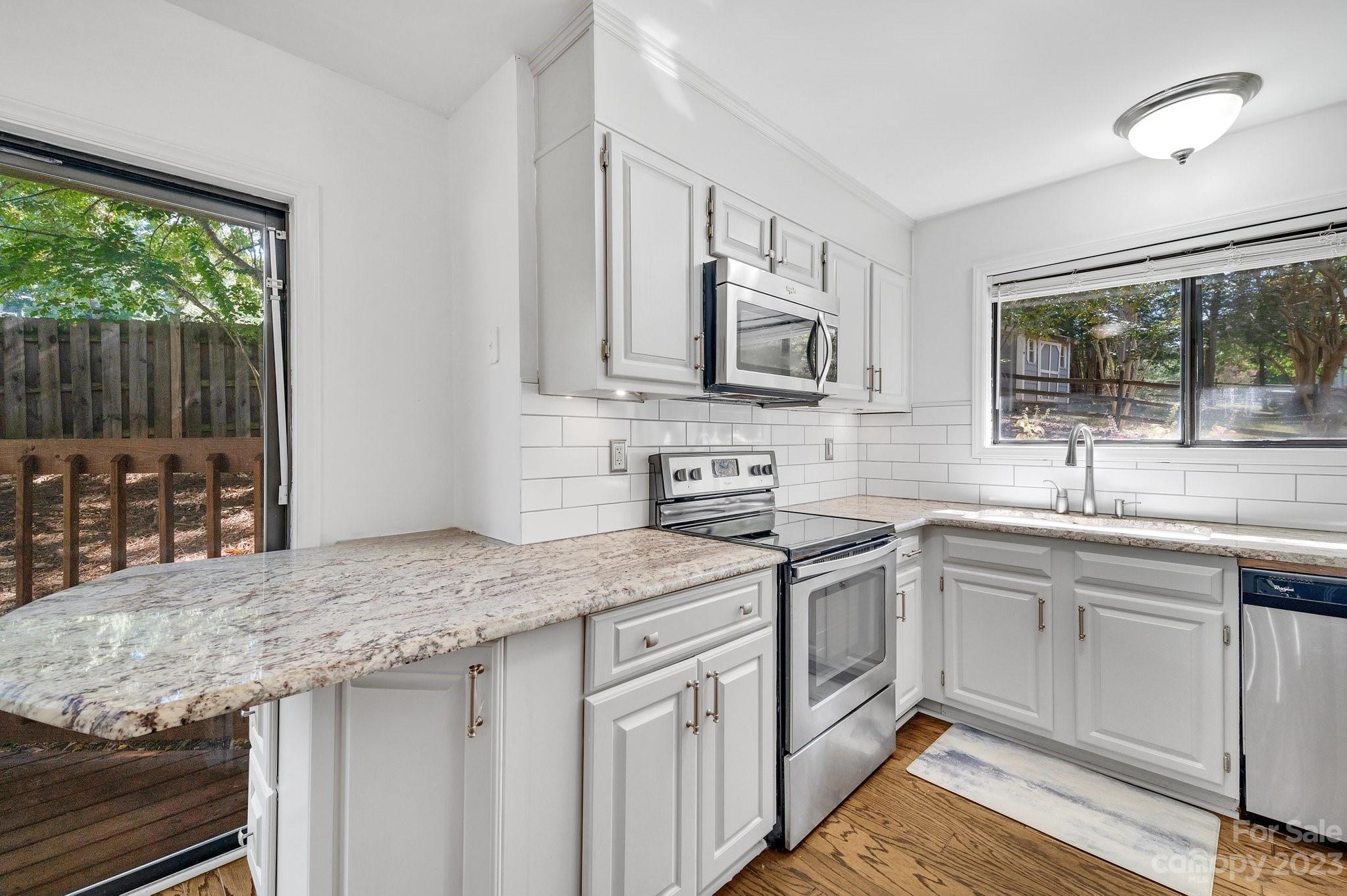1016 Palmyra Drive Tega Cay, SC 29708 - Photo 11 of 33 a kitchen with stainless steel appliances granite countertop a sink stove and cabinets