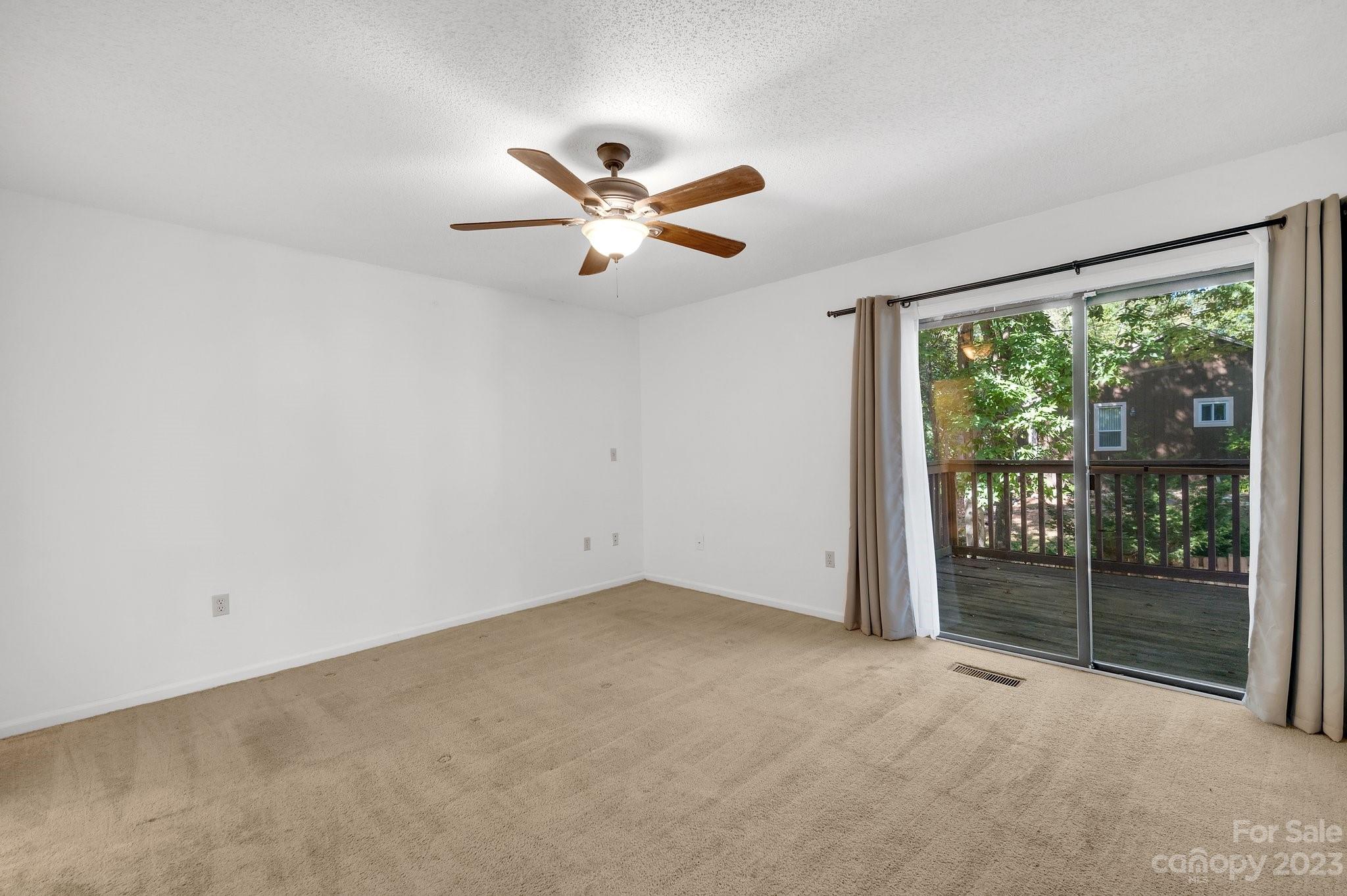 1016 Palmyra Drive Tega Cay, SC 29708 - Photo 13 of 33 an empty room with windows and ceiling fan