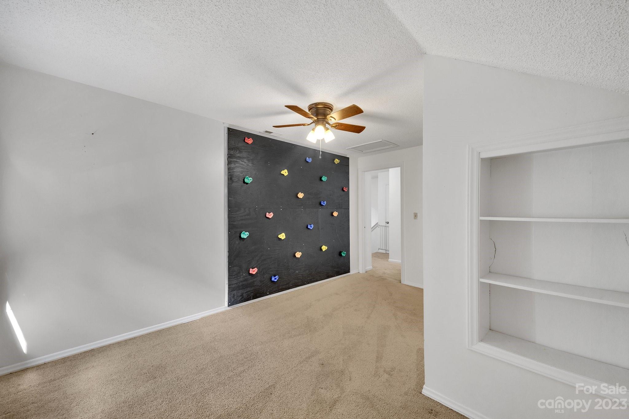 1016 Palmyra Drive Tega Cay, SC 29708 - Photo 17 of 33 a bedroom with a bed and a chandelier fan