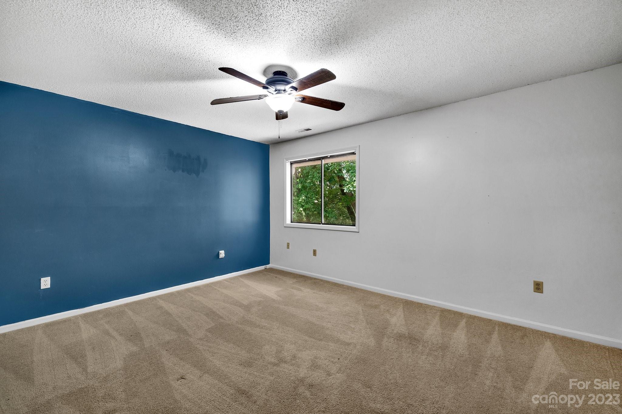 1016 Palmyra Drive Tega Cay, SC 29708 - Photo 19 of 33 an empty room with windows and fan
