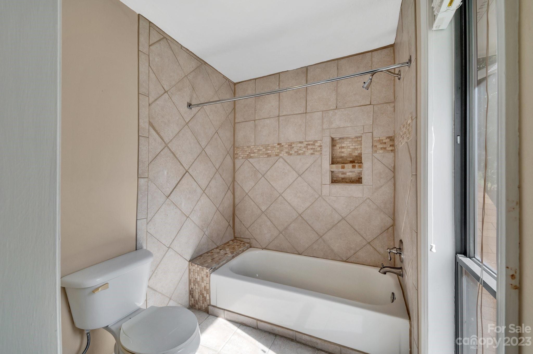 1016 Palmyra Drive Tega Cay, SC 29708 - Photo 22 of 33 a bathroom with a toilet and a bathtub