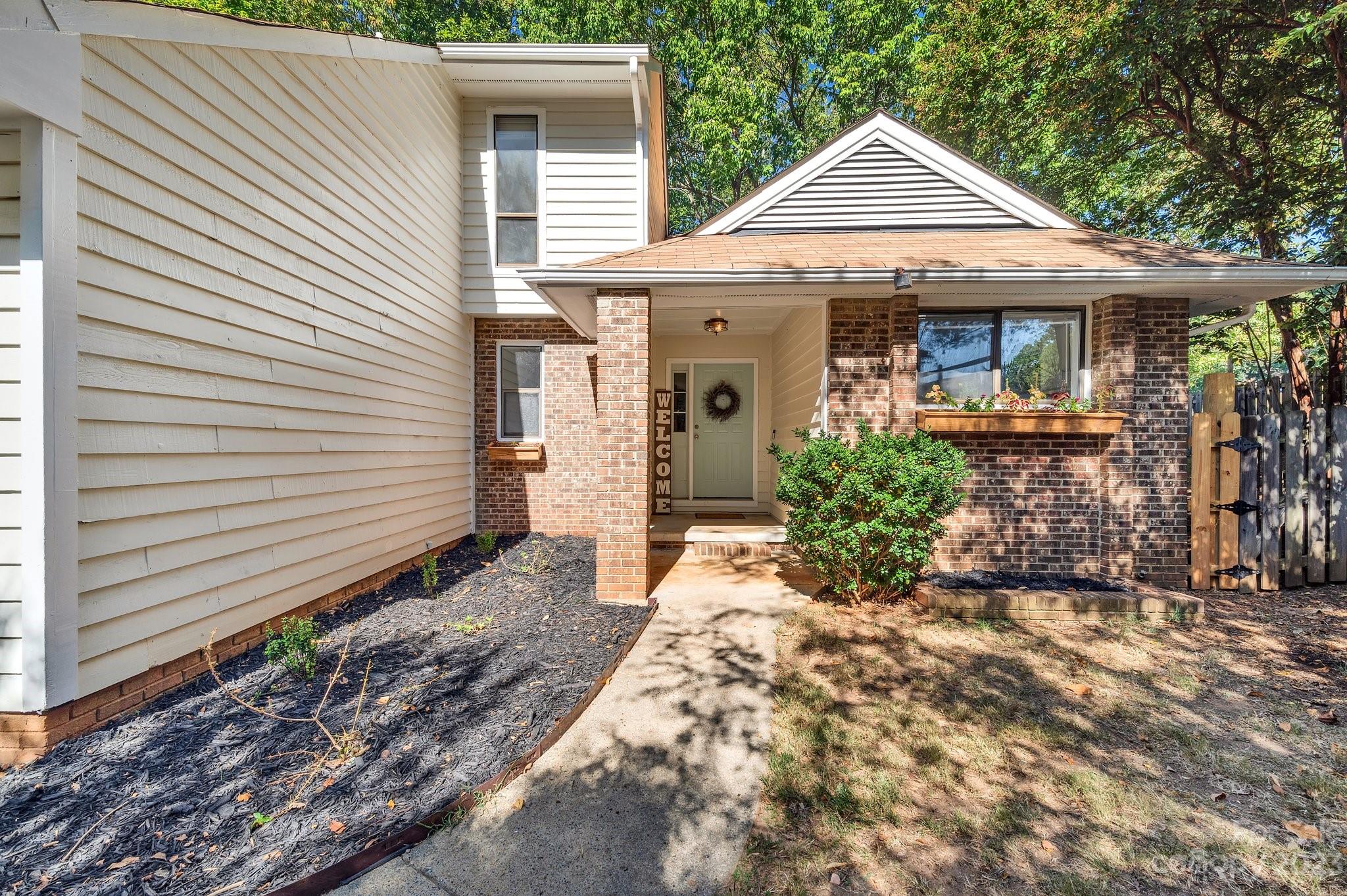 1016 Palmyra Drive Tega Cay, SC 29708 - Photo 4 of 33 a front view of a house with garden