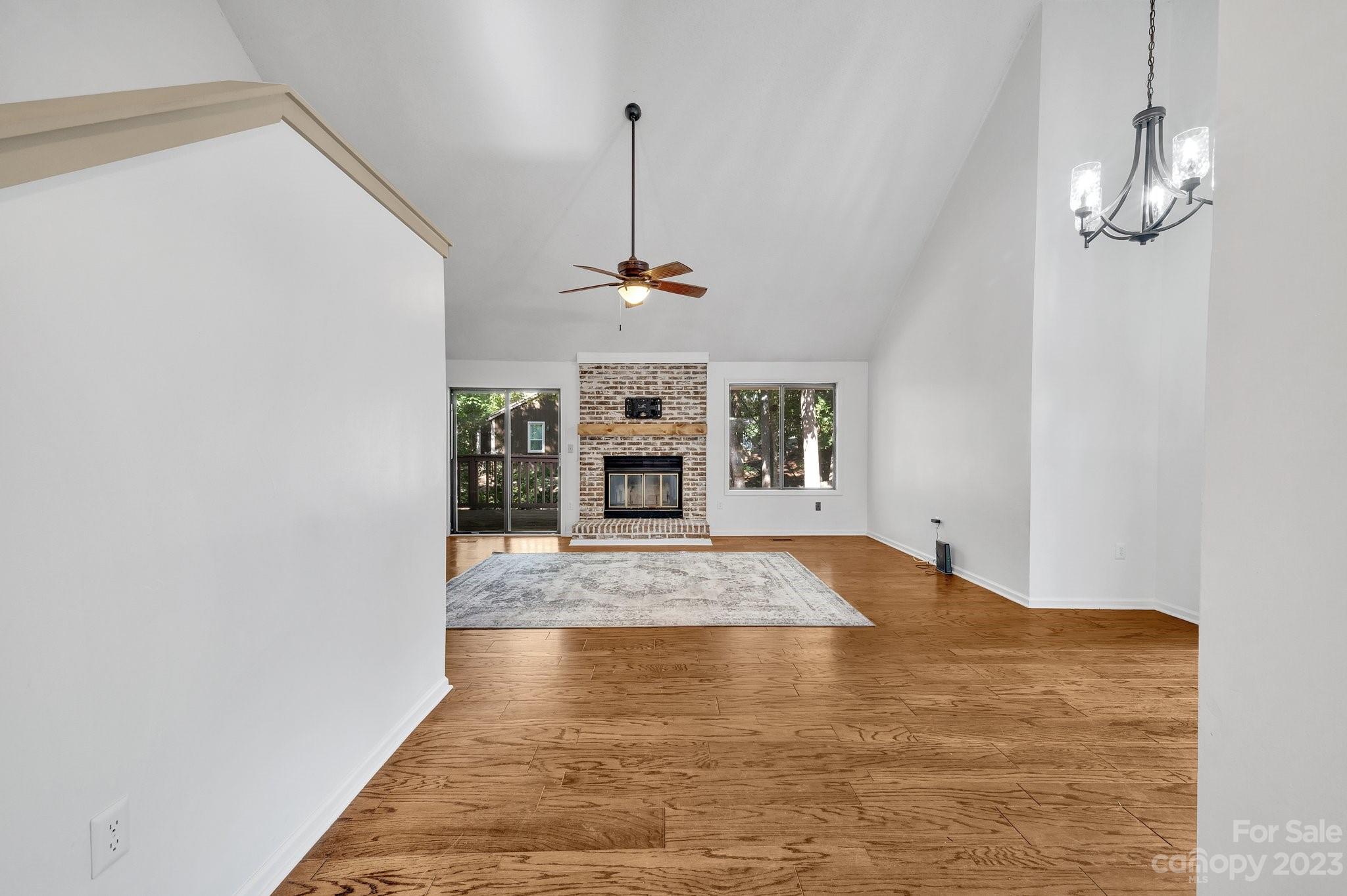 1016 Palmyra Drive Tega Cay, SC 29708 - Photo 6 of 33 a view of empty room with a fireplace and chandelier fan