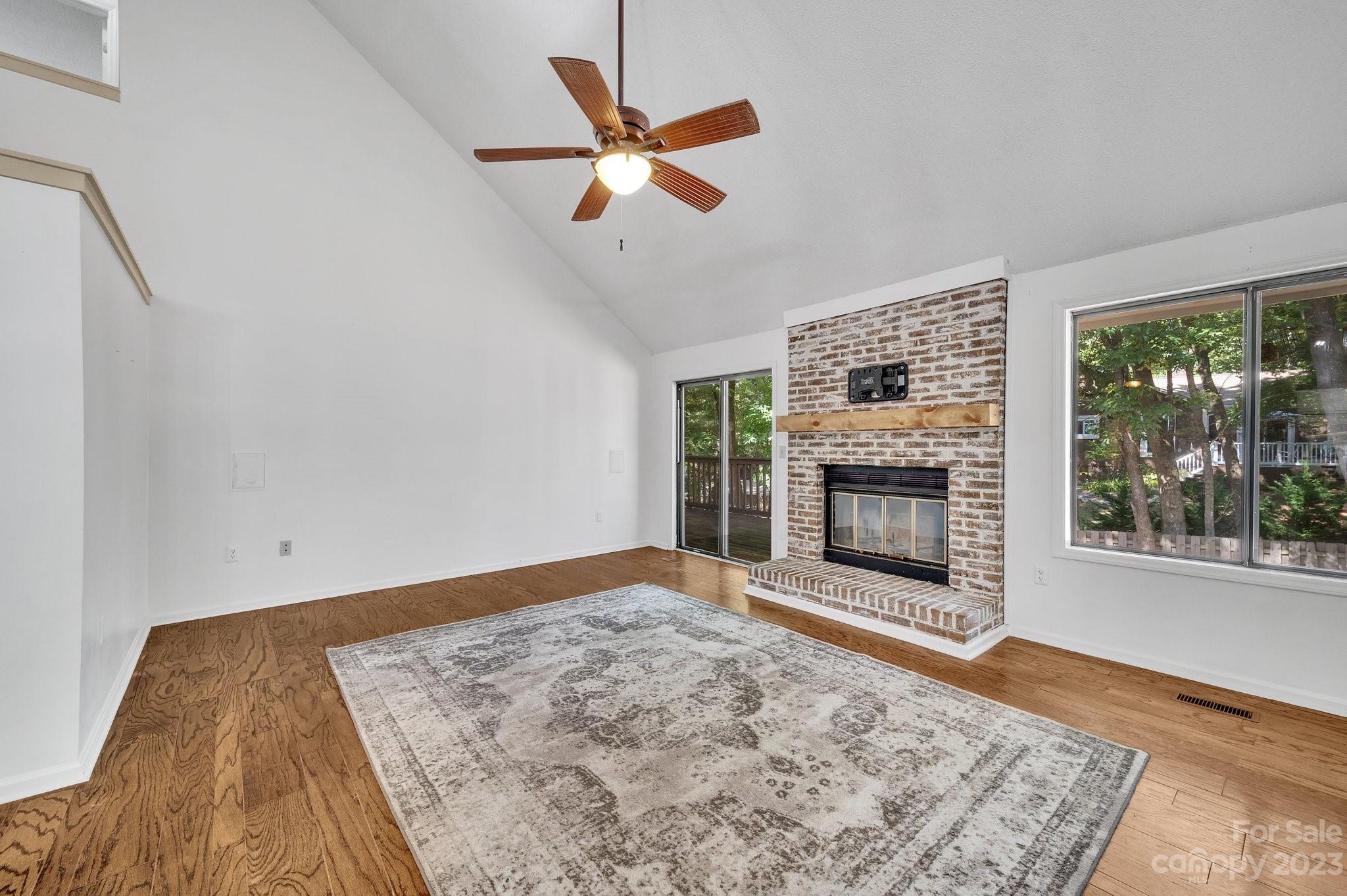 1016 Palmyra Drive Tega Cay, SC 29708 - Photo 7 of 33 wooden floor in an empty room with a fireplace