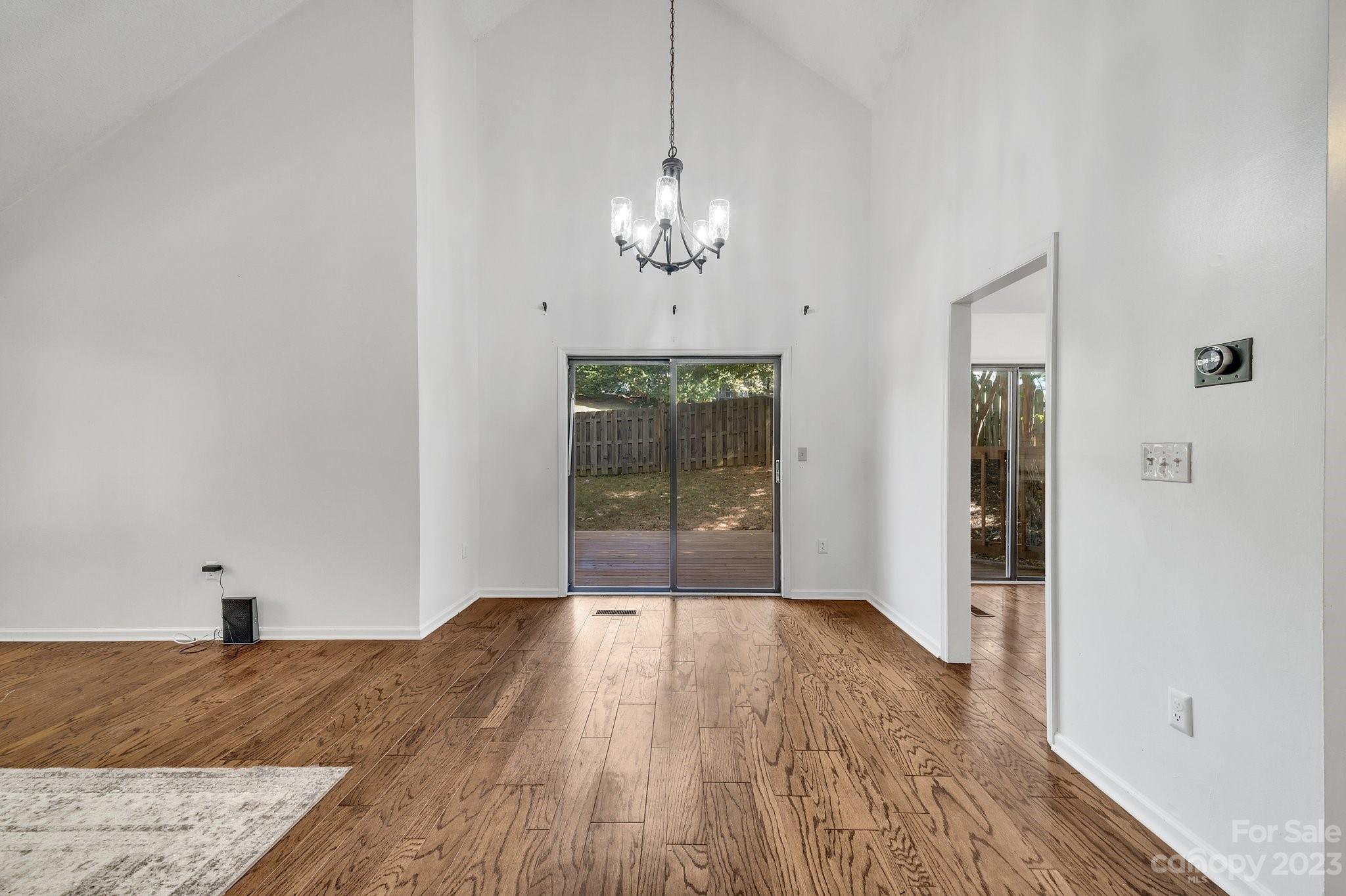1016 Palmyra Drive Tega Cay, SC 29708 - Photo 9 of 33 a view of a livingroom with wooden floor and a ceiling fan