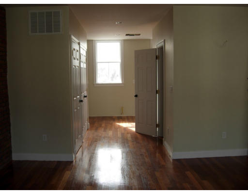 134 Marcella Street, Unit 2 Boston, MA 02119 - Photo 4 of 12 a view of hallway with window and wooden floor