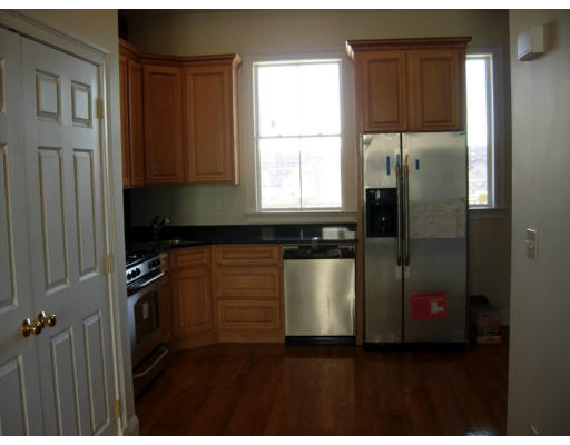 134 Marcella Street, Unit 2 Boston, MA 02119 - Photo 7 of 12 a kitchen with stainless steel appliances granite countertop a refrigerator and a sink