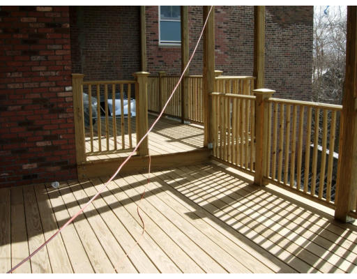 134 Marcella Street, Unit 2 Boston, MA 02119 - Photo 9 of 12 a view of balcony with wooden floor and fence