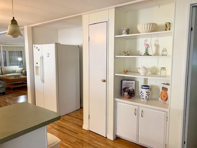 702 North Silver Circle Key Largo, FL 33037 - Photo 11 of 38 a view of kitchen with refrigerator cabinets and wooden floor