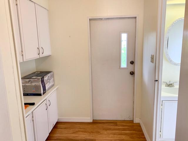 702 North Silver Circle Key Largo, FL 33037 - Photo 12 of 38 a kitchen with white cabinets and sink