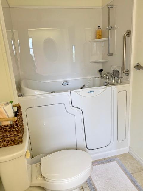 702 North Silver Circle Key Largo, FL 33037 - Photo 20 of 38 a bathroom with a granite countertop toilet sink and mirror