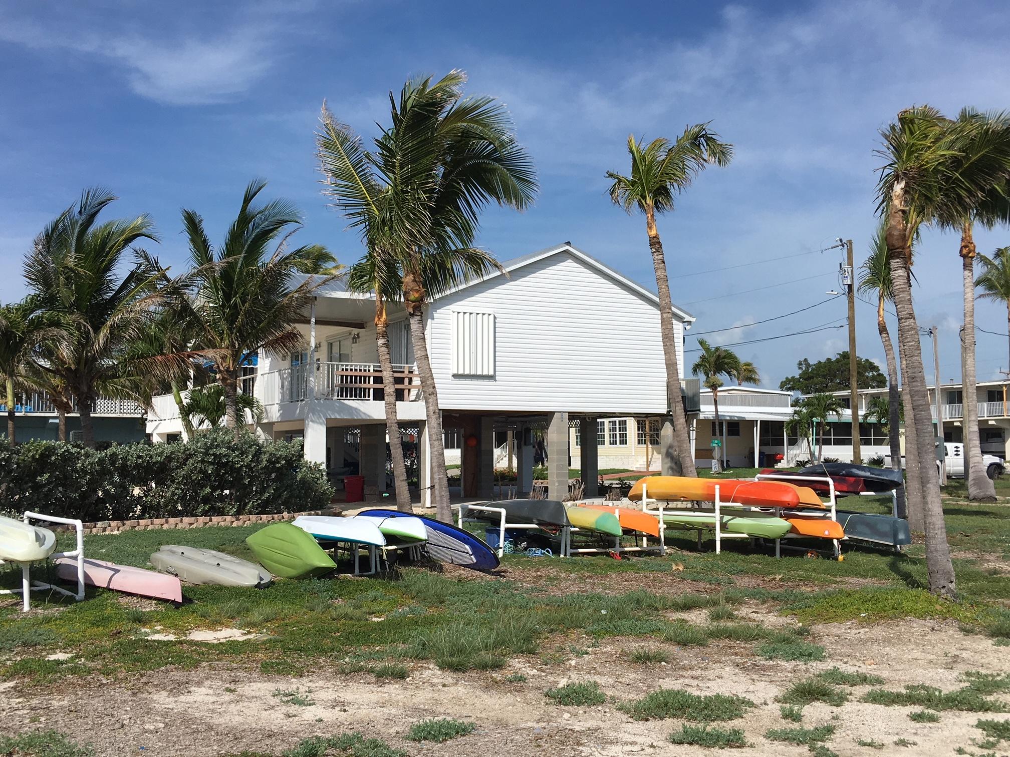 702 North Silver Circle Key Largo, FL 33037 - Photo 32 of 38 a front view of a house with garden and sitting area