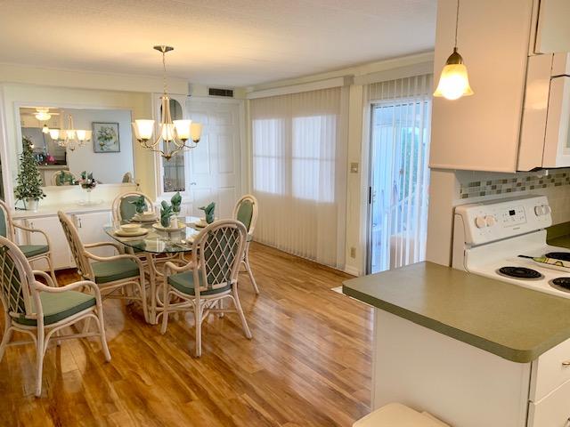 702 North Silver Circle Key Largo, FL 33037 - Photo 10 of 38 a view of a dining room with furniture and wooden floor