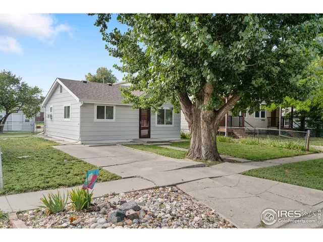 a front view of a house with a yard and a garage