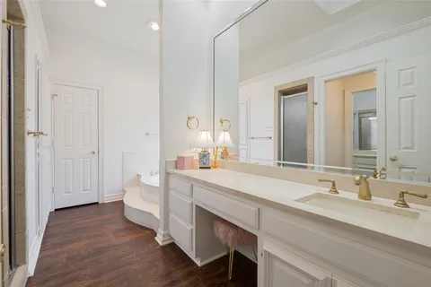 a spacious bathroom with a double vanity sink and a mirror