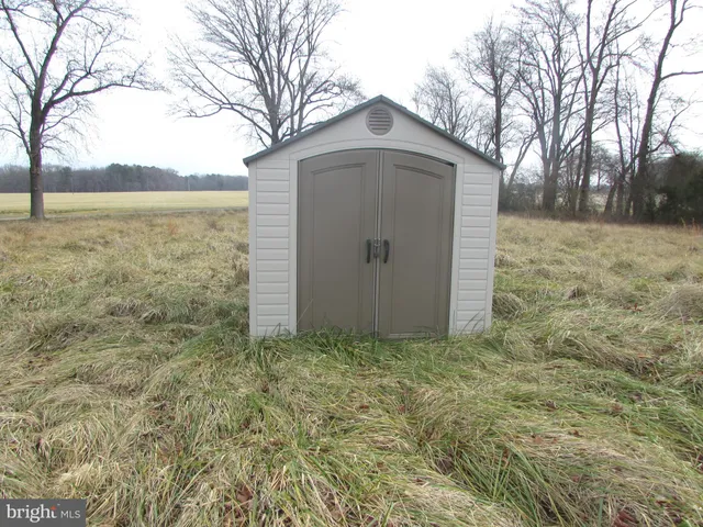 a view of a wooden door and a yard