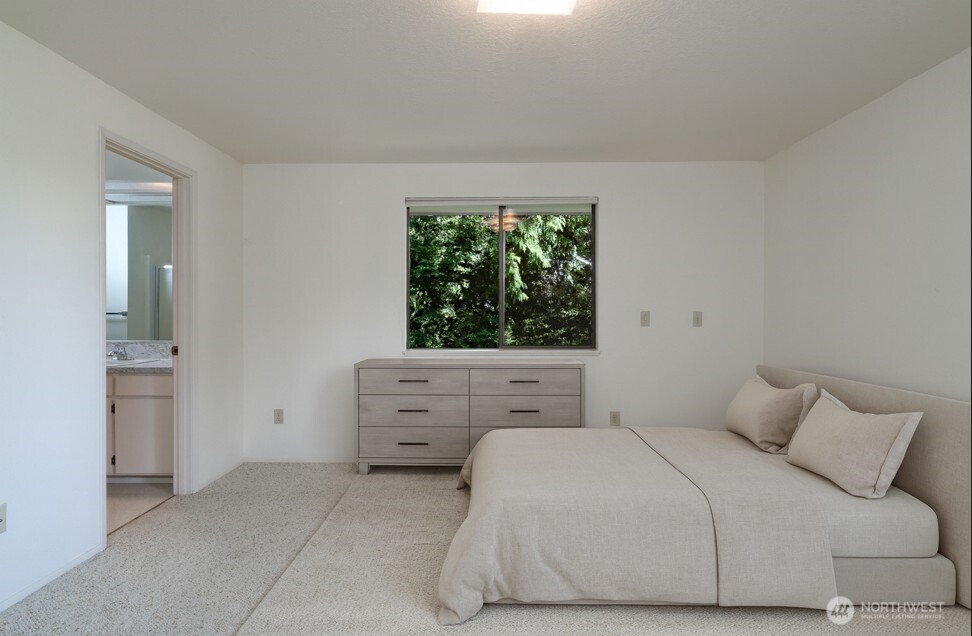 379 Snohomish Drive La Conner, WA 98257 - Photo 12 of 40 a bedroom with a bed and a window