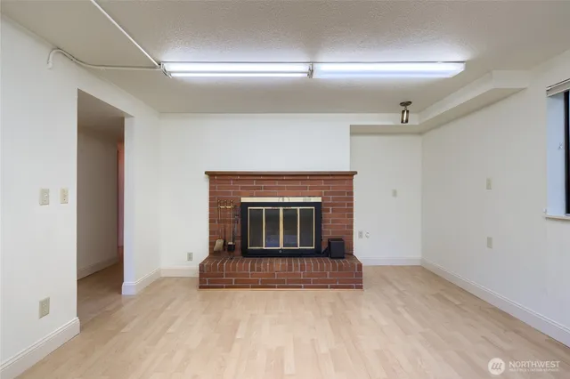 a view of an empty room with a fireplace