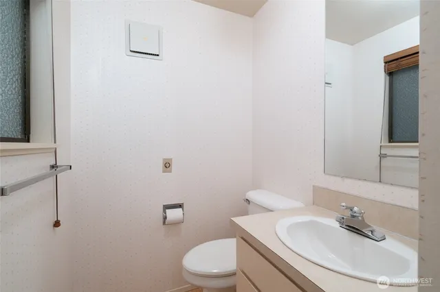 a bathroom with a sink toilet and mirror