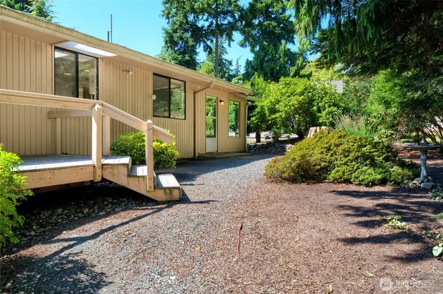 a view of a small house with a yard
