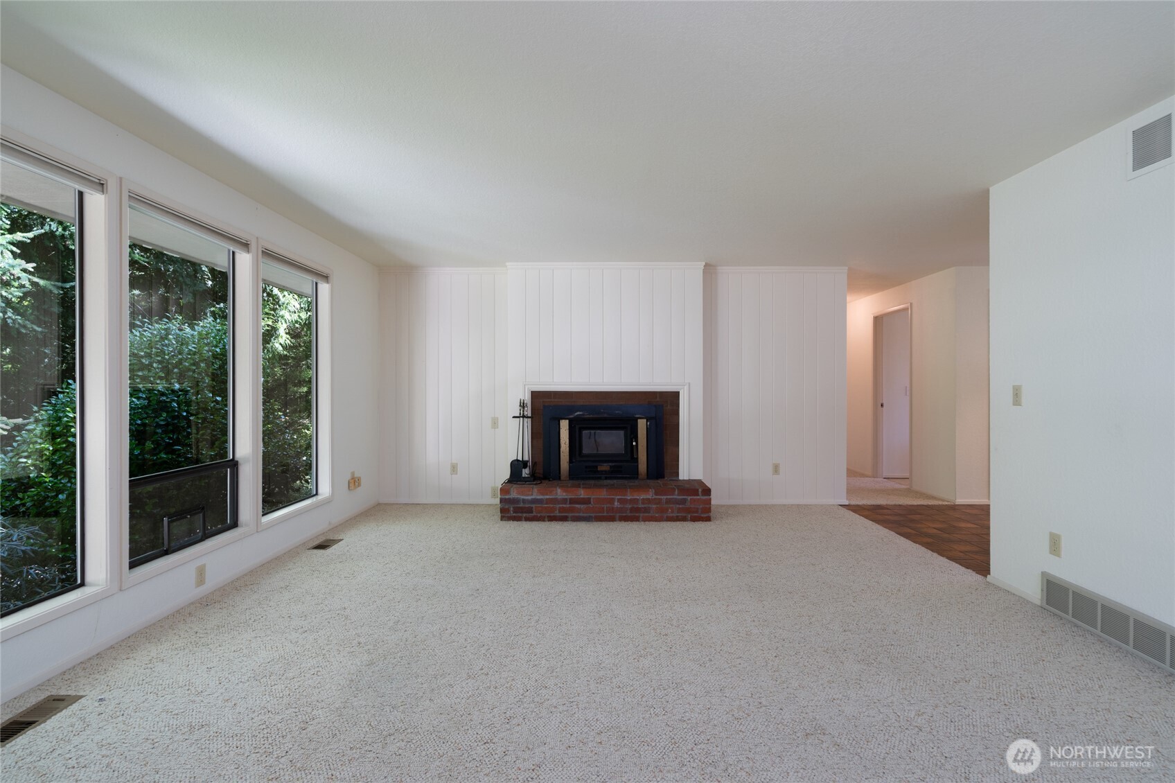 379 Snohomish Drive La Conner, WA 98257 - Photo 6 of 40 a view of an empty room with a fireplace and a window