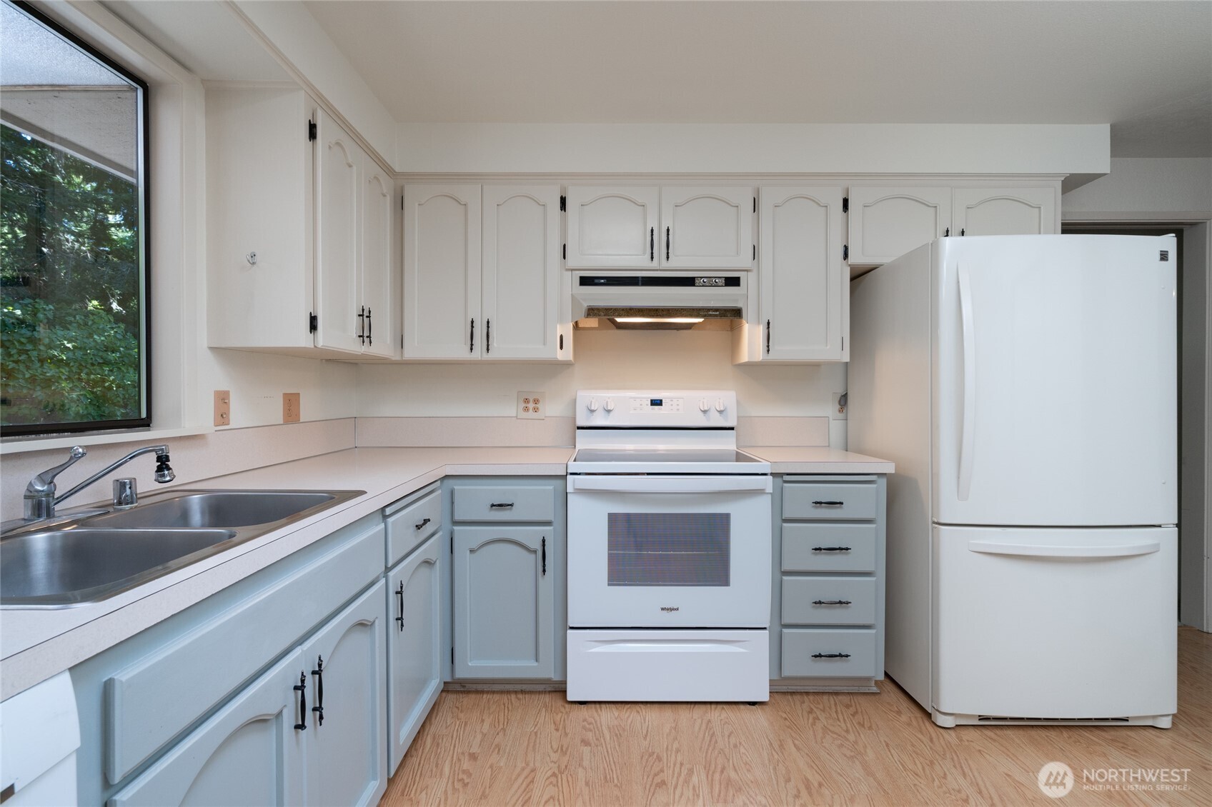 379 Snohomish Drive La Conner, WA 98257 - Photo 7 of 40 a kitchen with white cabinets and white appliances