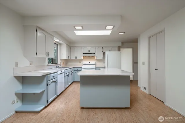 a kitchen with stainless steel appliances a sink stove and cabinets