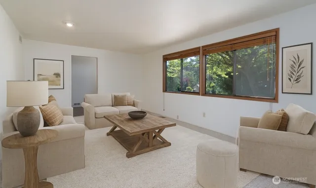 a living room with furniture and a floor to ceiling window