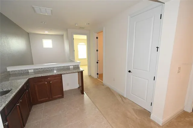 an empty room with a window and a dresser