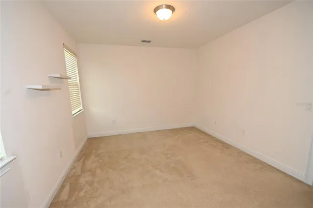 an empty room with windows and closet
