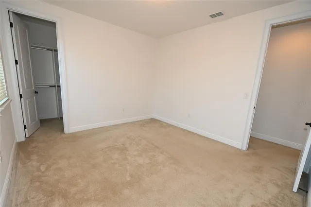 a view of a house with a yard and potted plants