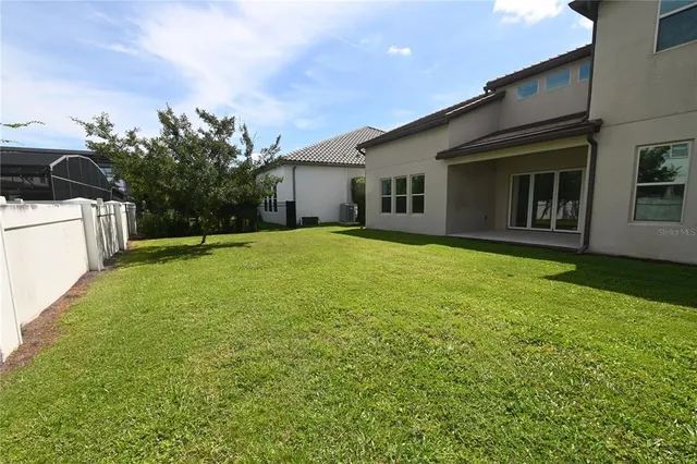 a front view of a house with a garden and trees