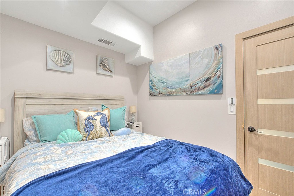 99 A Surfside Avenue Surfside, CA 90743 - Photo 12 of 75 a bedroom with a bed and wooden floor
